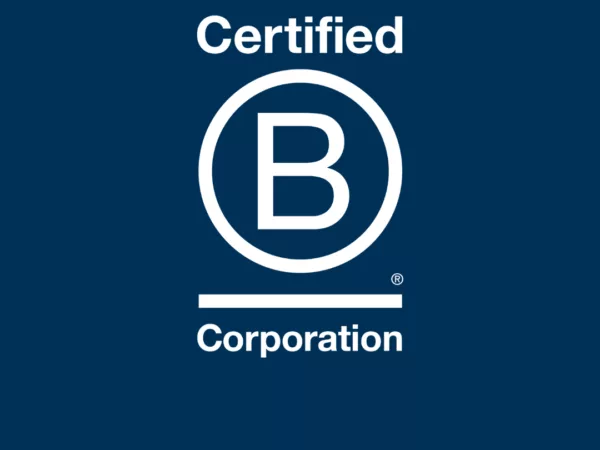 B Corp logo on a navy blue background, with three orange stripes at the bottom