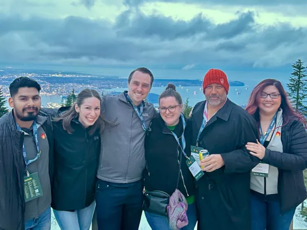 Six Beneficial State Bank team members stand on Grouse Mountain in Vancouver, BC at the 2024 Champions Retreat, a conference for B Corps held every two years.