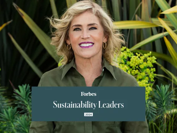 Kat Taylor smiles at camera with Forbes Sustainability Leaders graphic