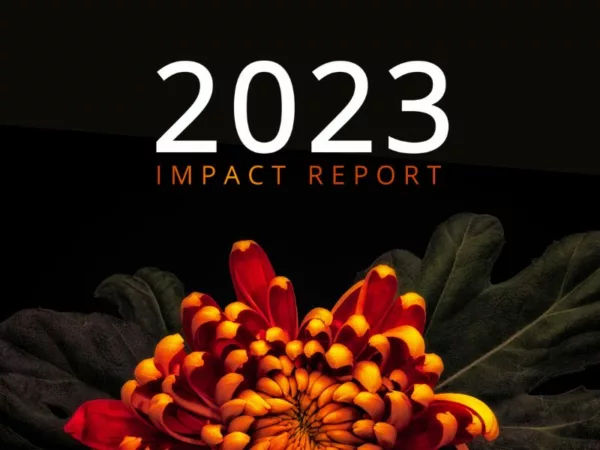 Image of a flower on a black background with text reading '2023 Impact Report'