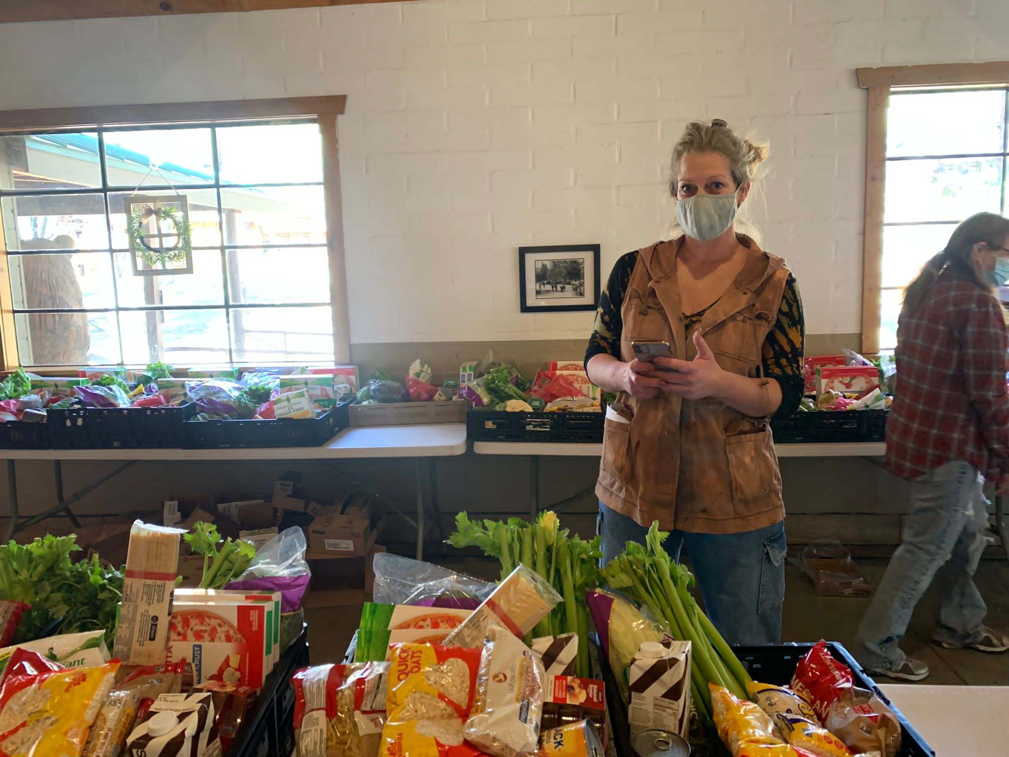 A volunteer in a mask packages food for distribution, a program of Idyllwild Forest Health Project's mutual aid's efforts